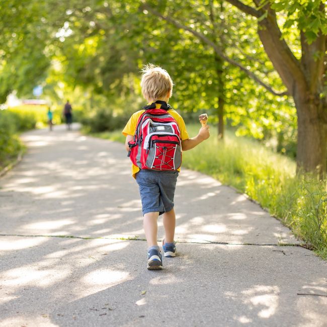 A parent and child holding hands